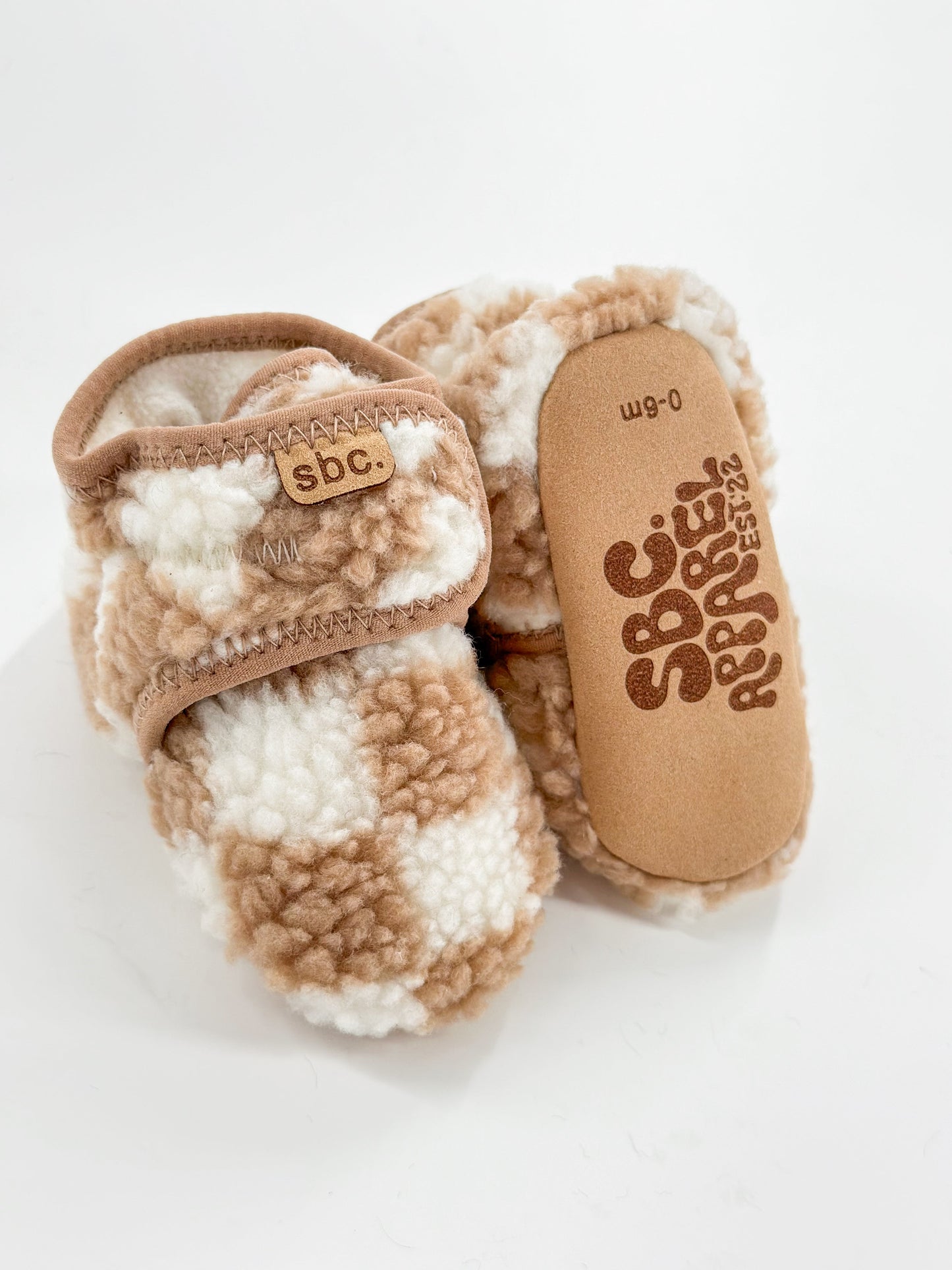 The Newborn Sherpa Bootie — Camel + White Checkered